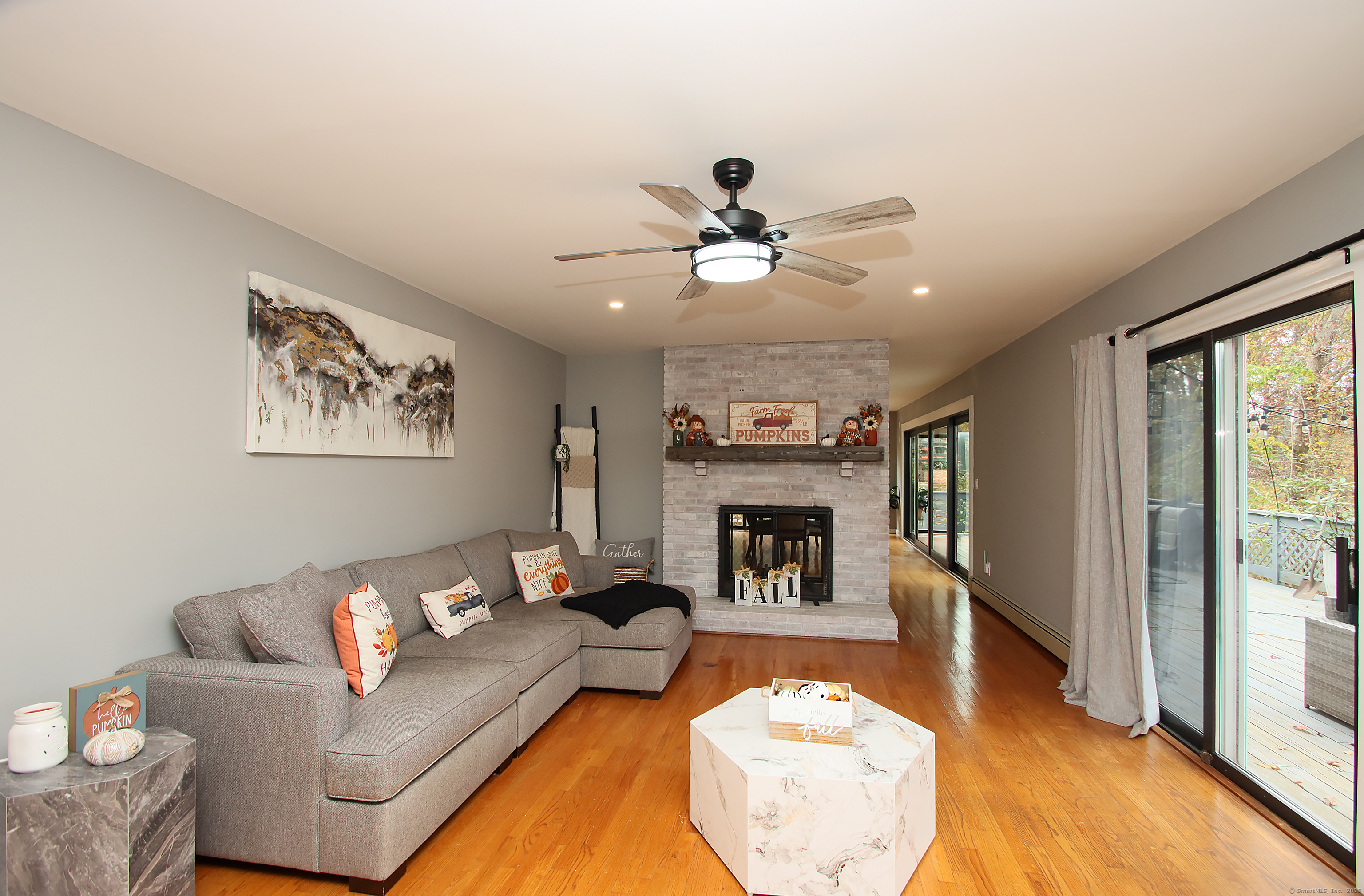 821 Essex Road Westbrook, CT 06498 - Photo 17 of 40 a living room with furniture and a fireplace
