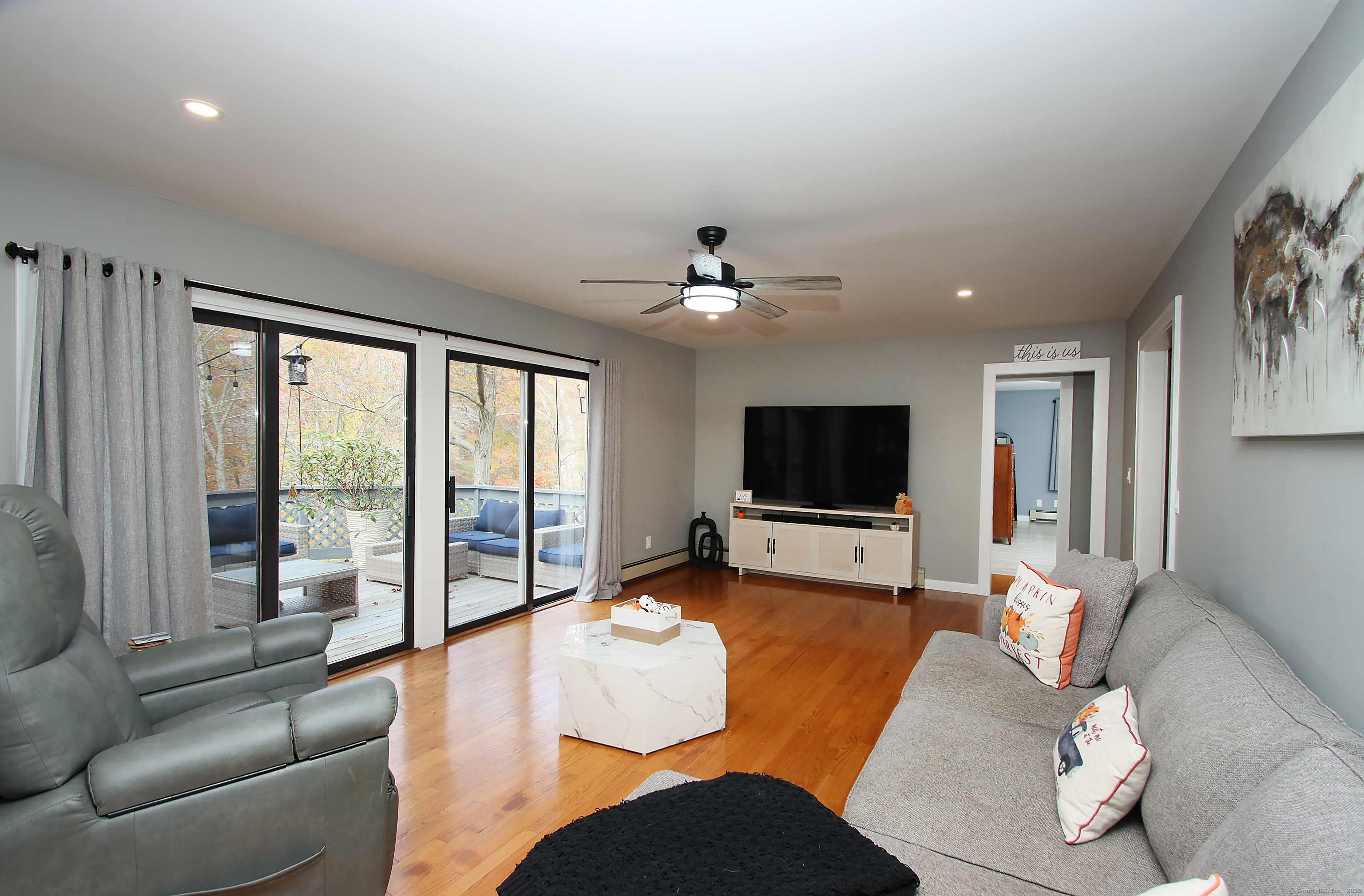 821 Essex Road Westbrook, CT 06498 - Photo 18 of 40 a living room with furniture and a flat screen tv