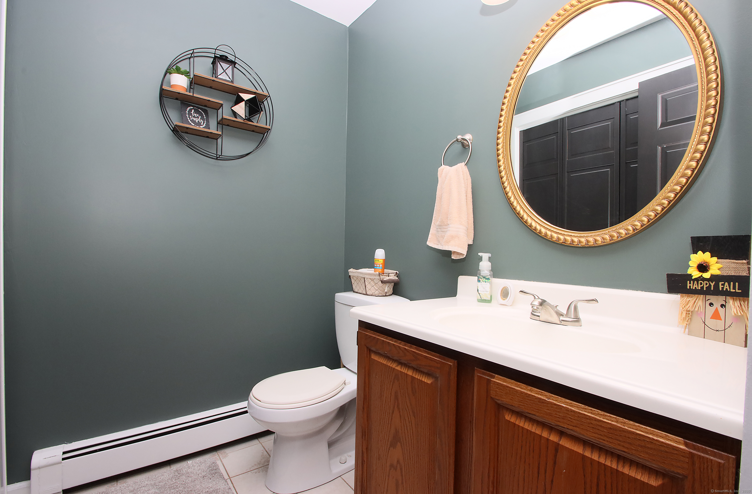 821 Essex Road Westbrook, CT 06498 - Photo 19 of 40 a bathroom with a sink mirror and toilet