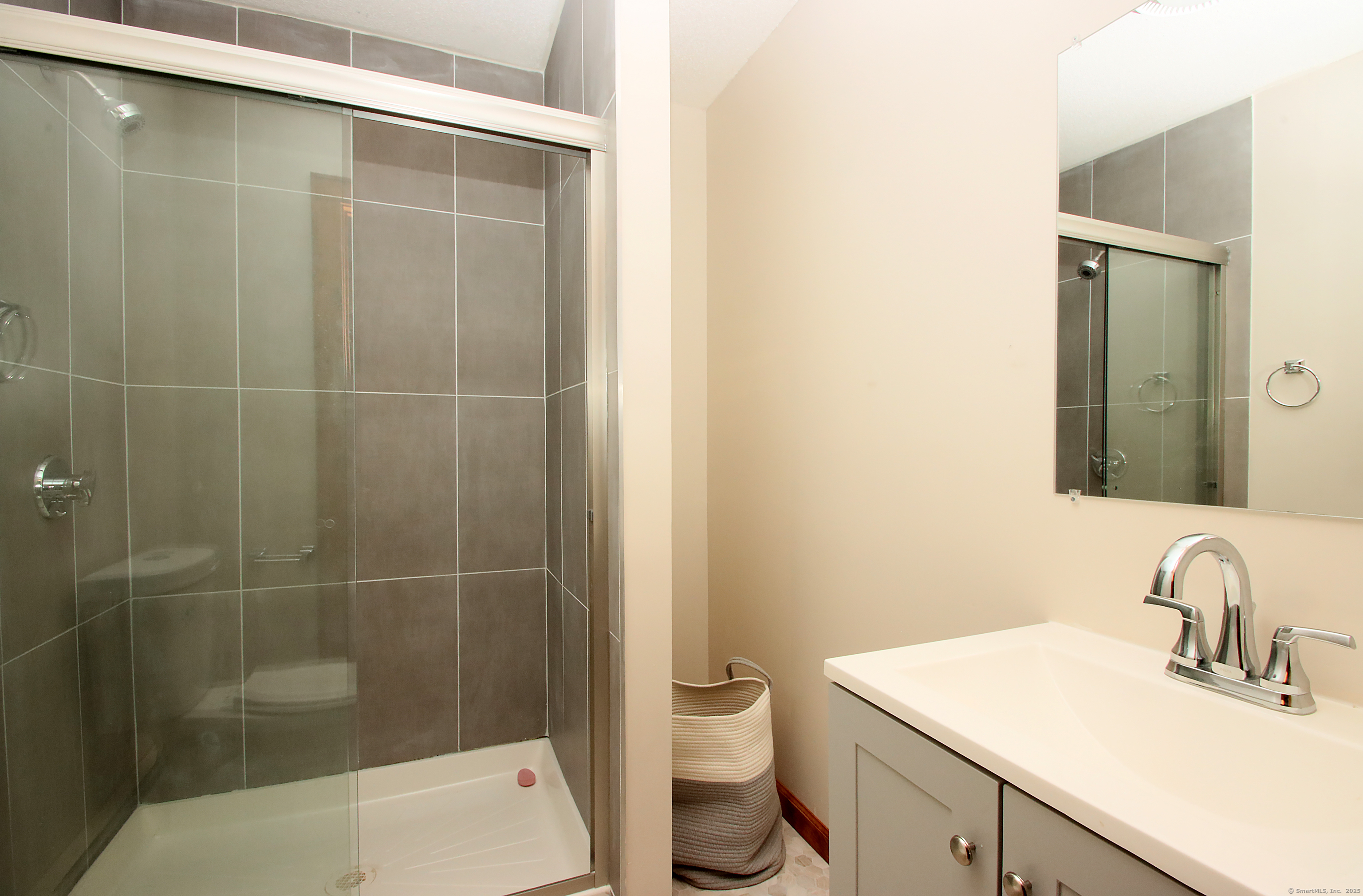 821 Essex Road Westbrook, CT 06498 - Photo 20 of 40 a bathroom with a sink a toilet and shower