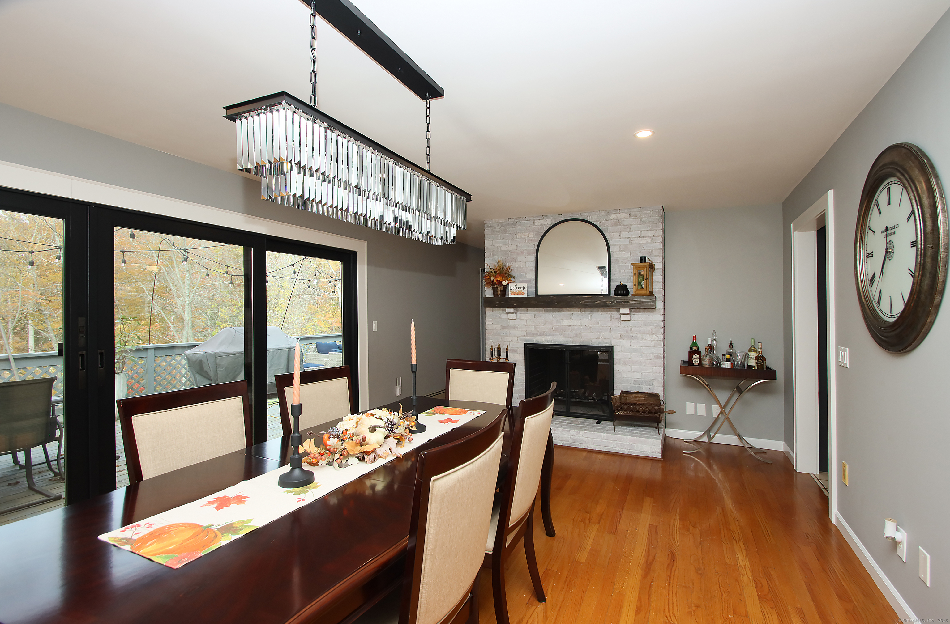 821 Essex Road Westbrook, CT 06498 - Photo 22 of 40 a view of a livingroom with furniture a fireplace wooden floor and a fireplace