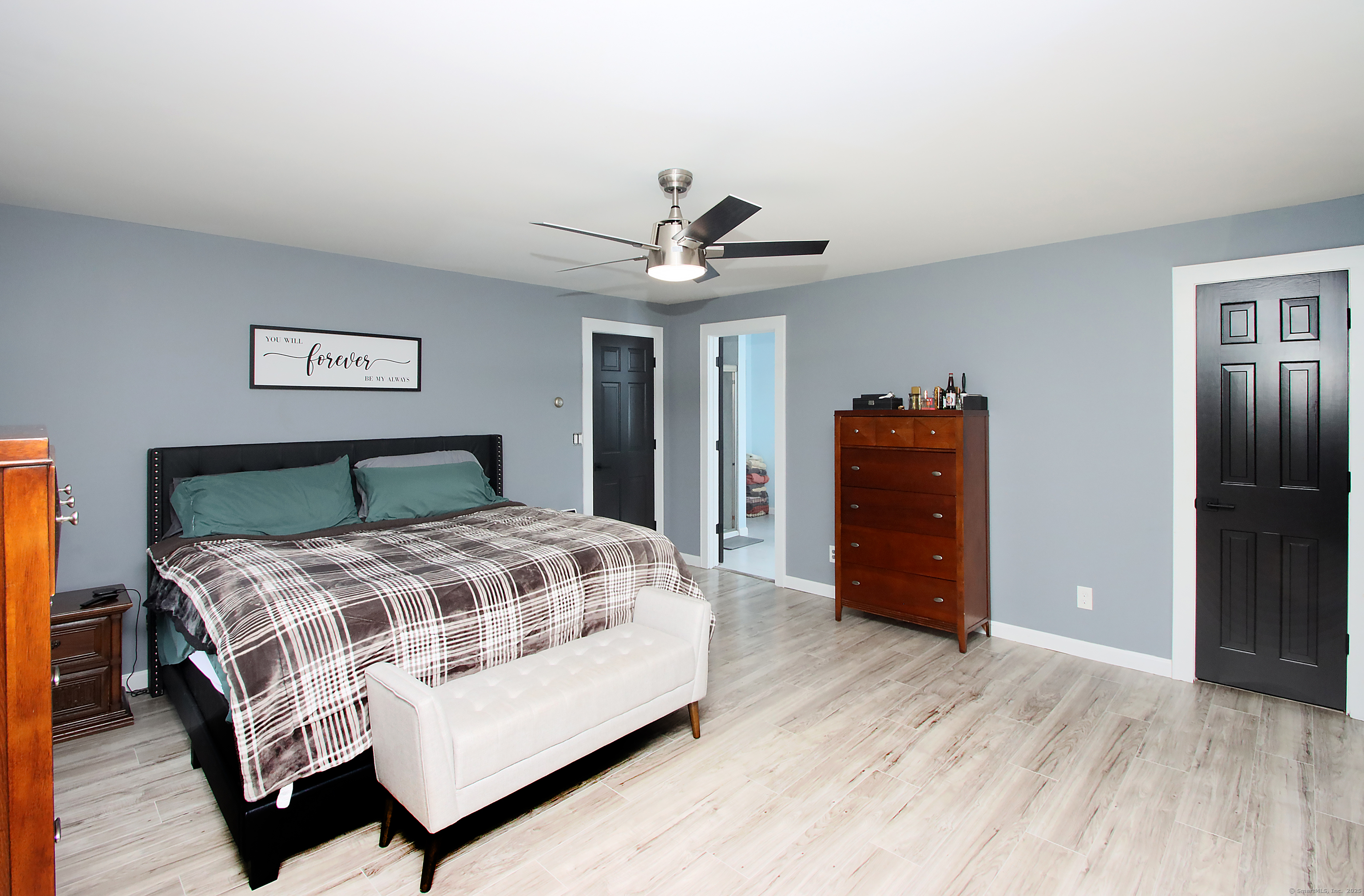 821 Essex Road Westbrook, CT 06498 - Photo 24 of 40 a bedroom with a bed and wooden floor