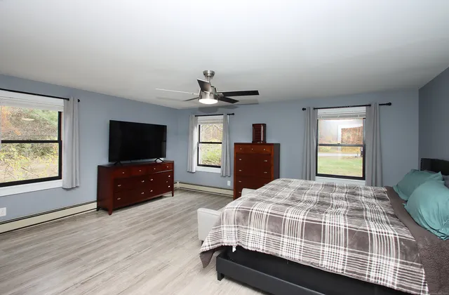 a bedroom with a bed and a flat screen tv