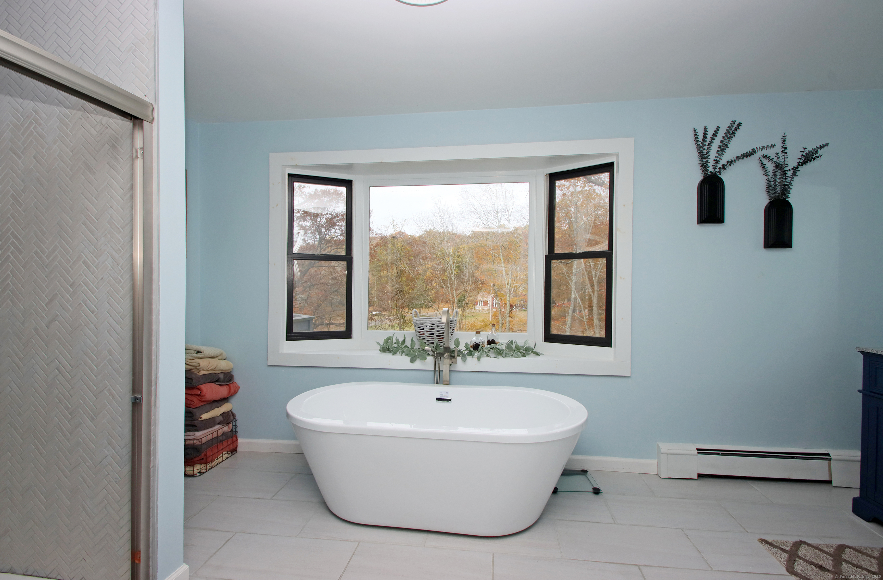 821 Essex Road Westbrook, CT 06498 - Photo 27 of 40 a white bath tub sitting in a bathroom next to a window
