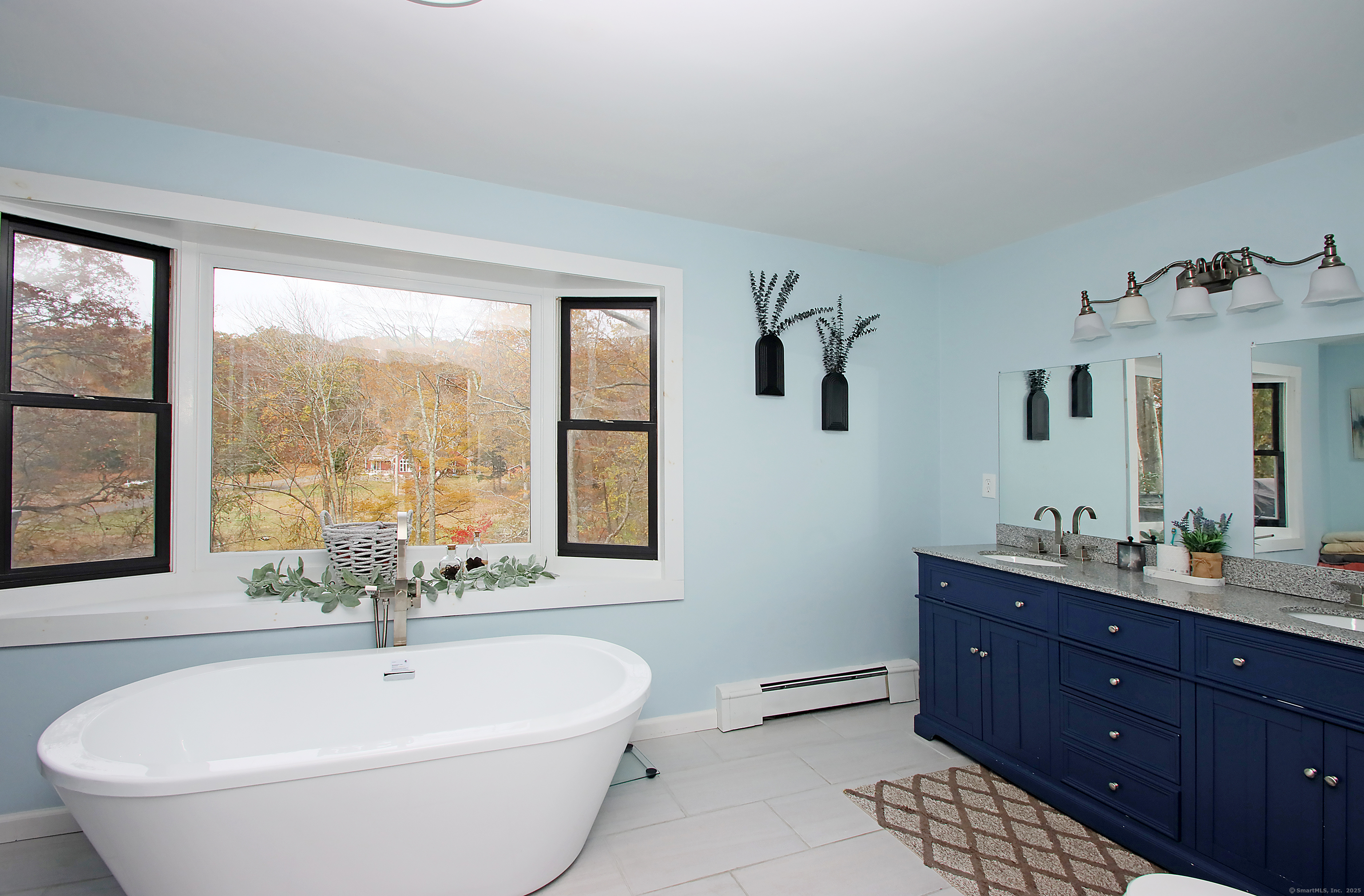 821 Essex Road Westbrook, CT 06498 - Photo 28 of 40 a spacious bathroom with a bathtub sink and mirror