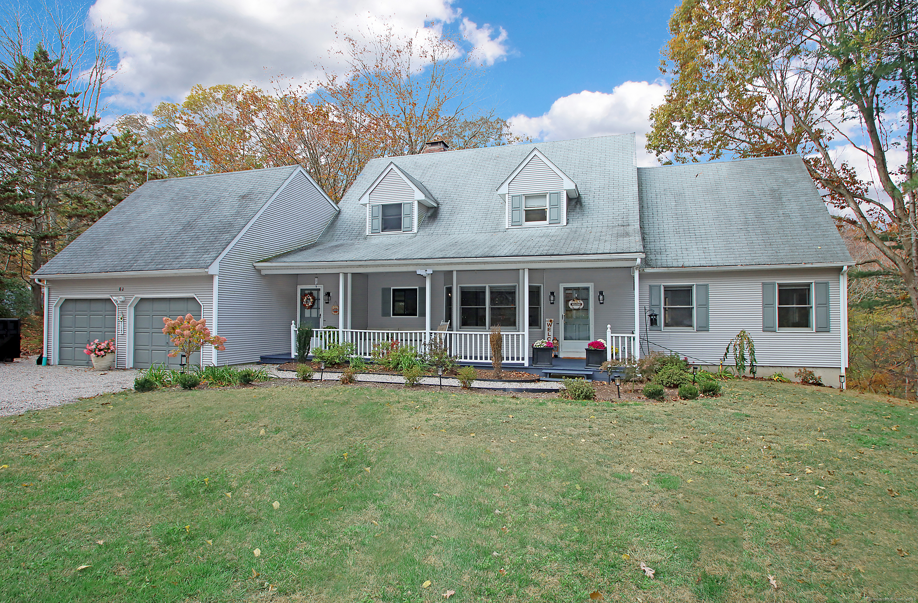 821 Essex Road Westbrook, CT 06498 - Photo 3 of 40 a front view of a house with a garden and porch