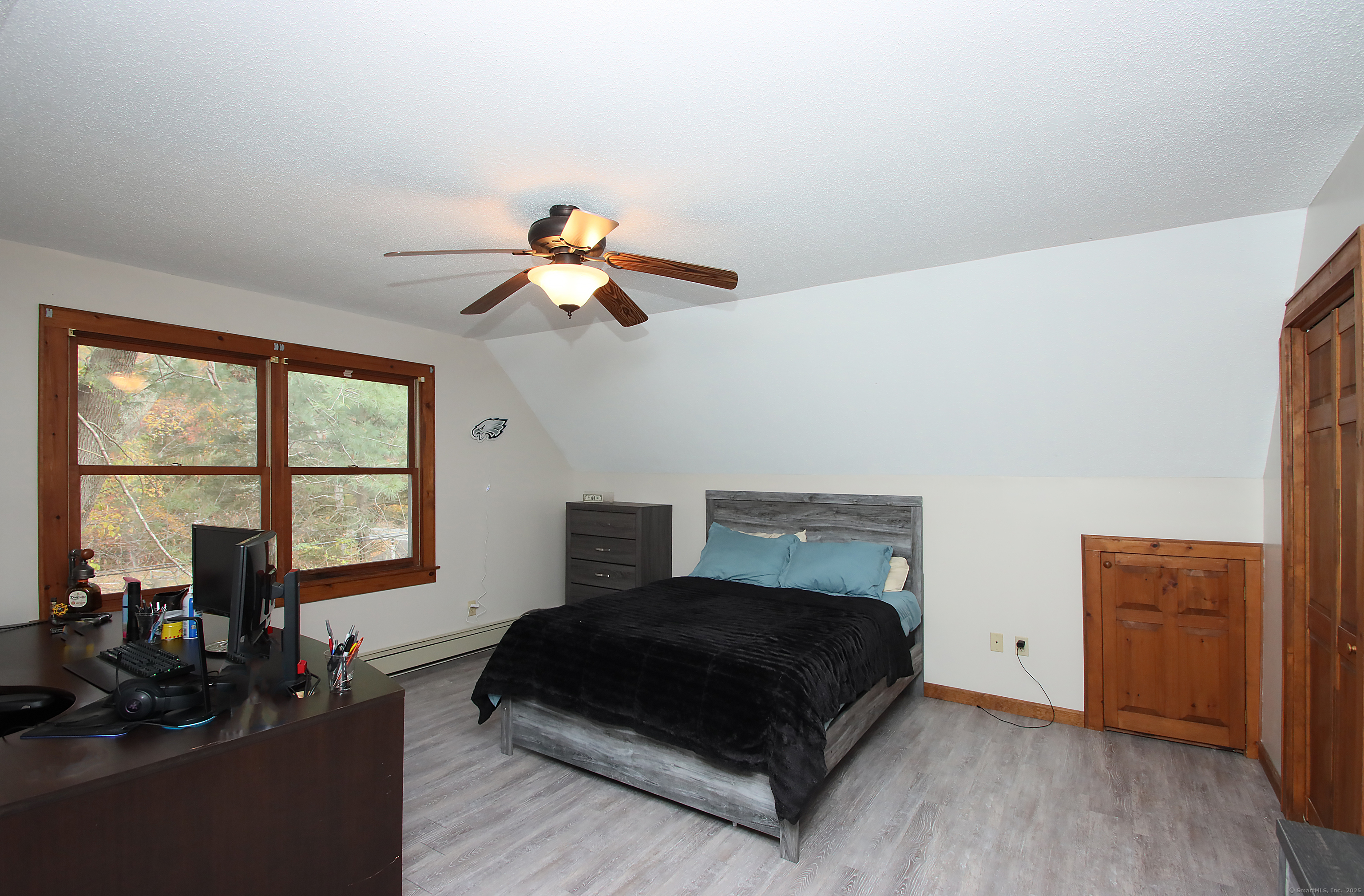 821 Essex Road Westbrook, CT 06498 - Photo 33 of 40 a bedroom with a bed and wooden floor