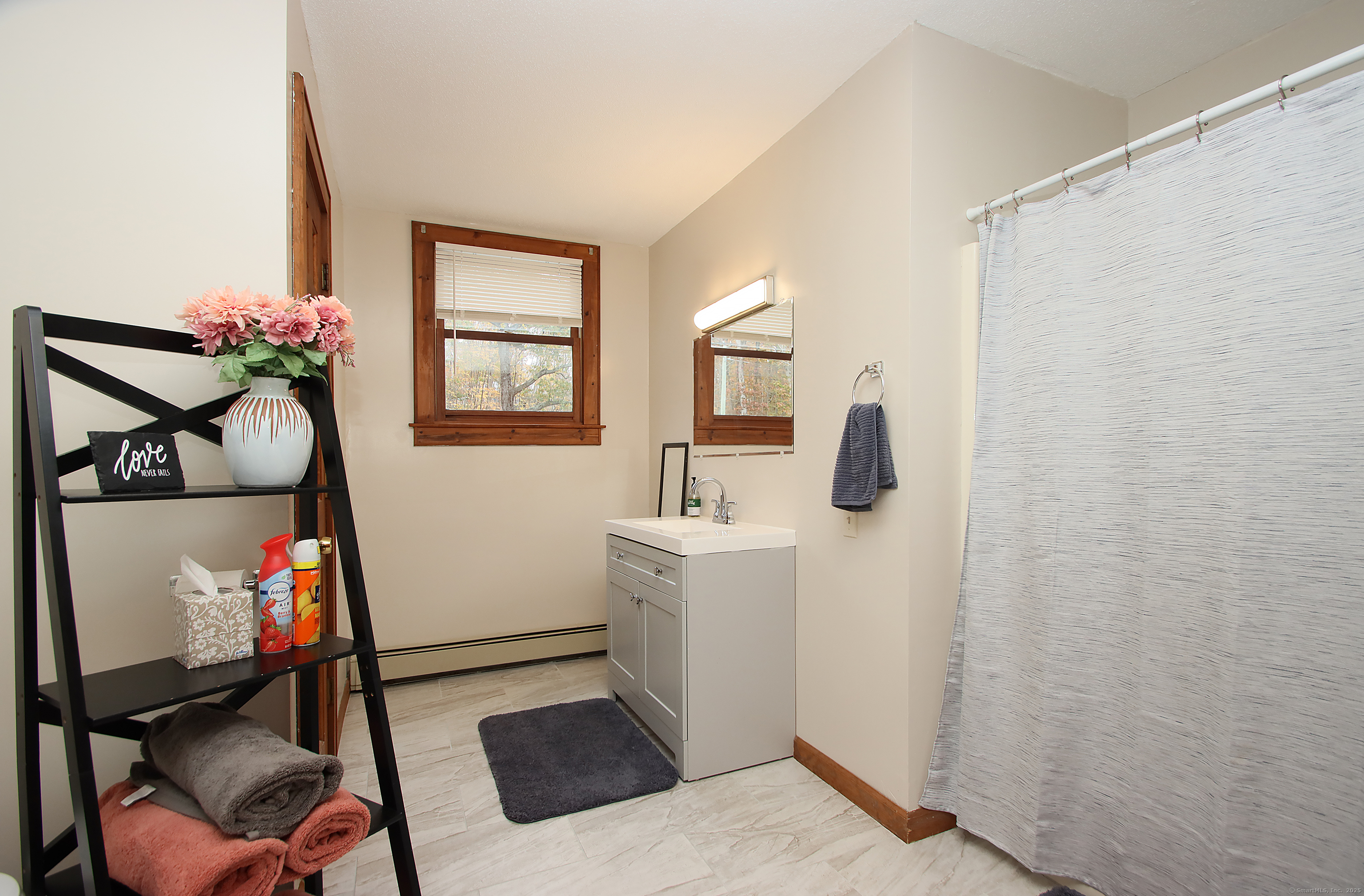 821 Essex Road Westbrook, CT 06498 - Photo 34 of 40 a bathroom with a sink mirror and toilet