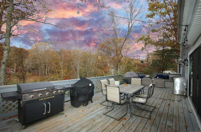 a view of a patio with couches table and chairs and potted plants