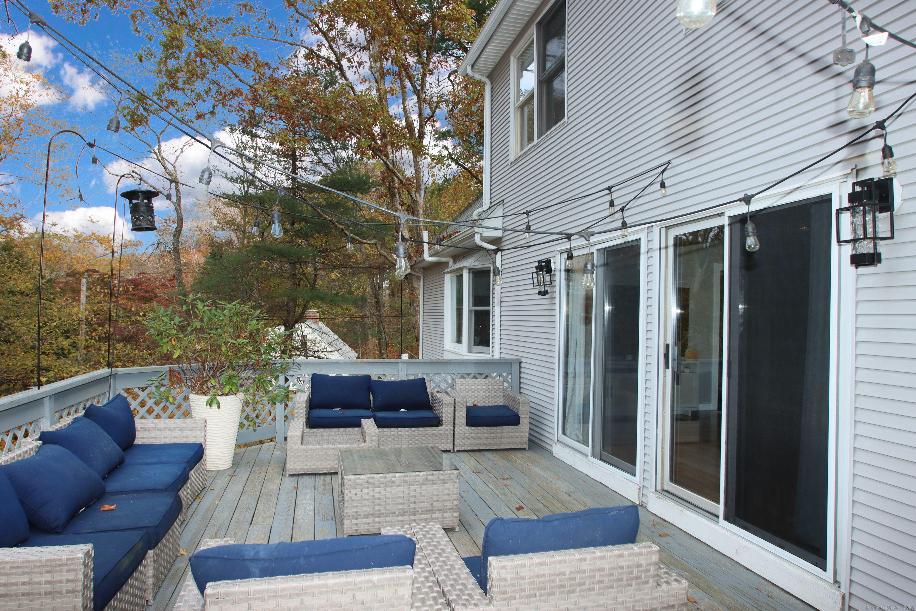 821 Essex Road Westbrook, CT 06498 - Photo 38 of 40 a view of a patio with couches table and chairs and potted plants