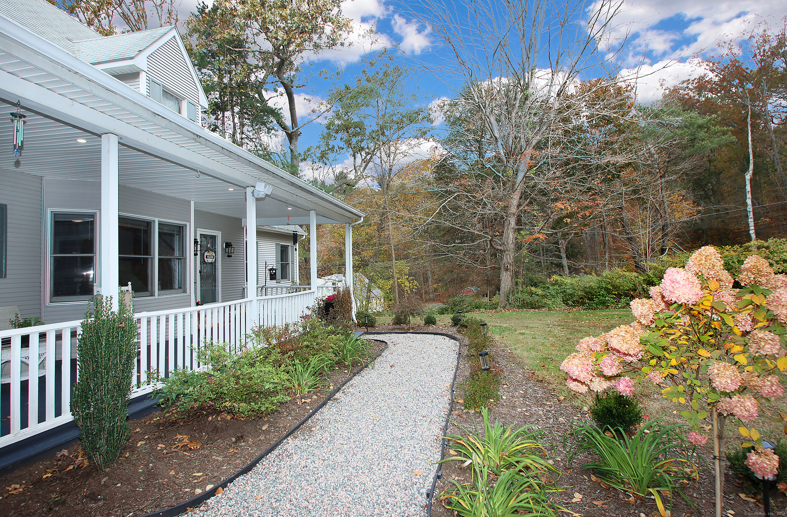 821 Essex Road Westbrook, CT 06498 - Photo 6 of 40 a front view of a house with a yard