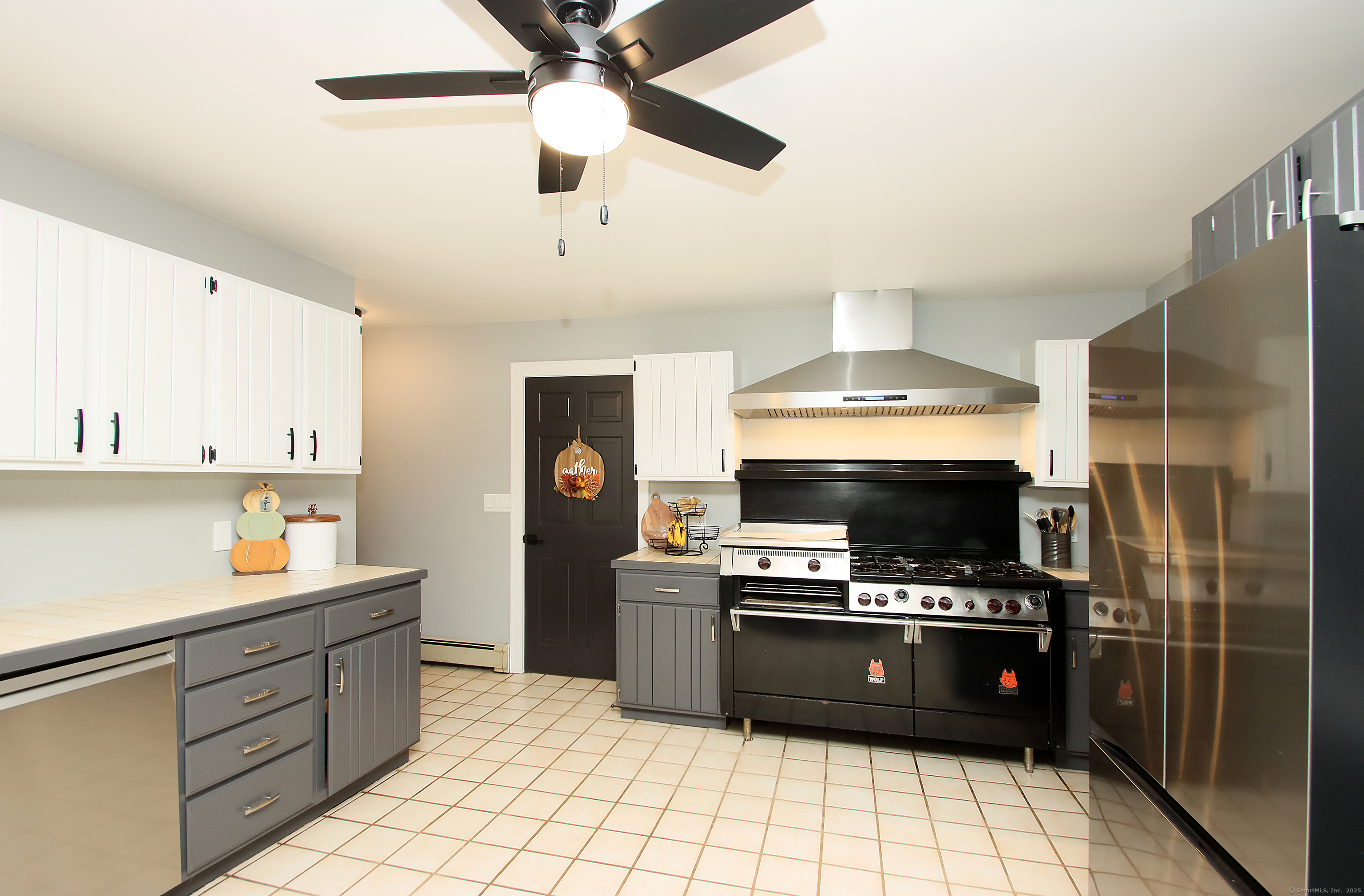 821 Essex Road Westbrook, CT 06498 - Photo 8 of 40 a kitchen with a stove a microwave and a refrigerator