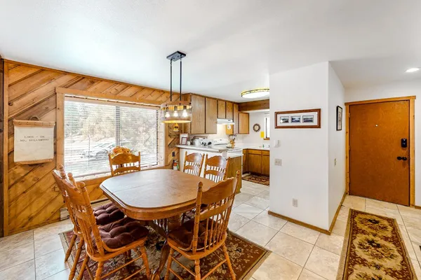 a dining room with furniture and a window