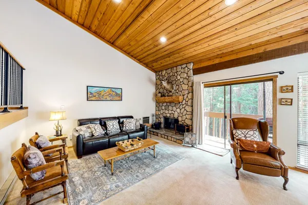 a living room with furniture a flat screen tv and a large window