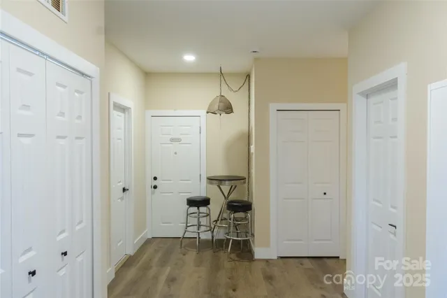 a view of a hallway with wooden floor