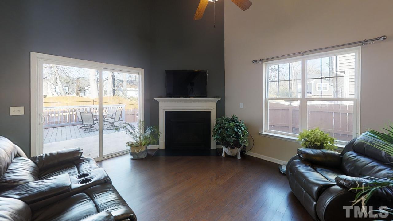 504 Smith Ridge Way Fuquay-Varina, NC 27526 - Photo 3 of 20 Contemporary natural gas fireplace with vaulted ceilings and sliding door to outside deck/garden area