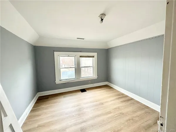 an empty room with a empty space and windows