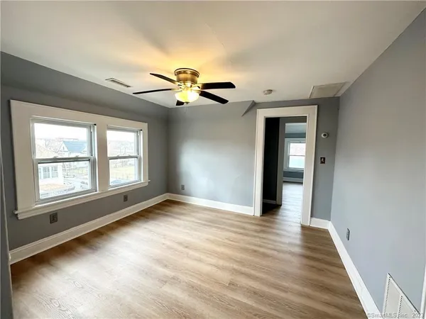 wooden floor in an empty room with a window