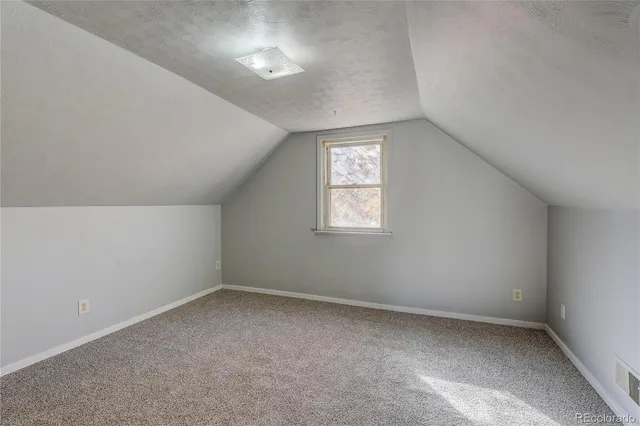 an empty room with closet and bathroom