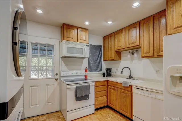 a kitchen with a sink cabinets stainless steel appliances and a window