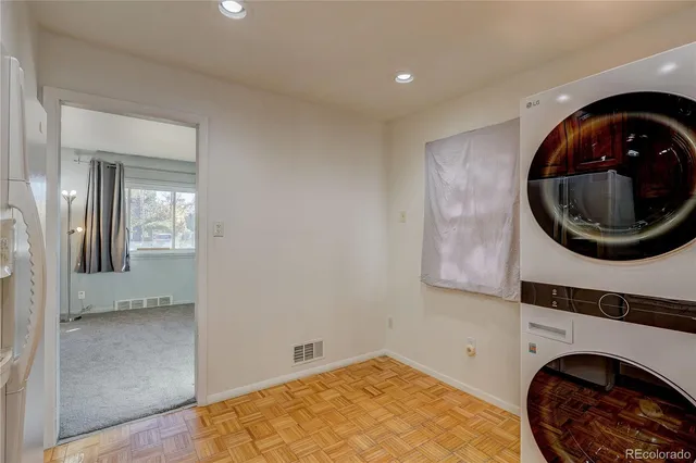 a room with a washing machine and a mirror