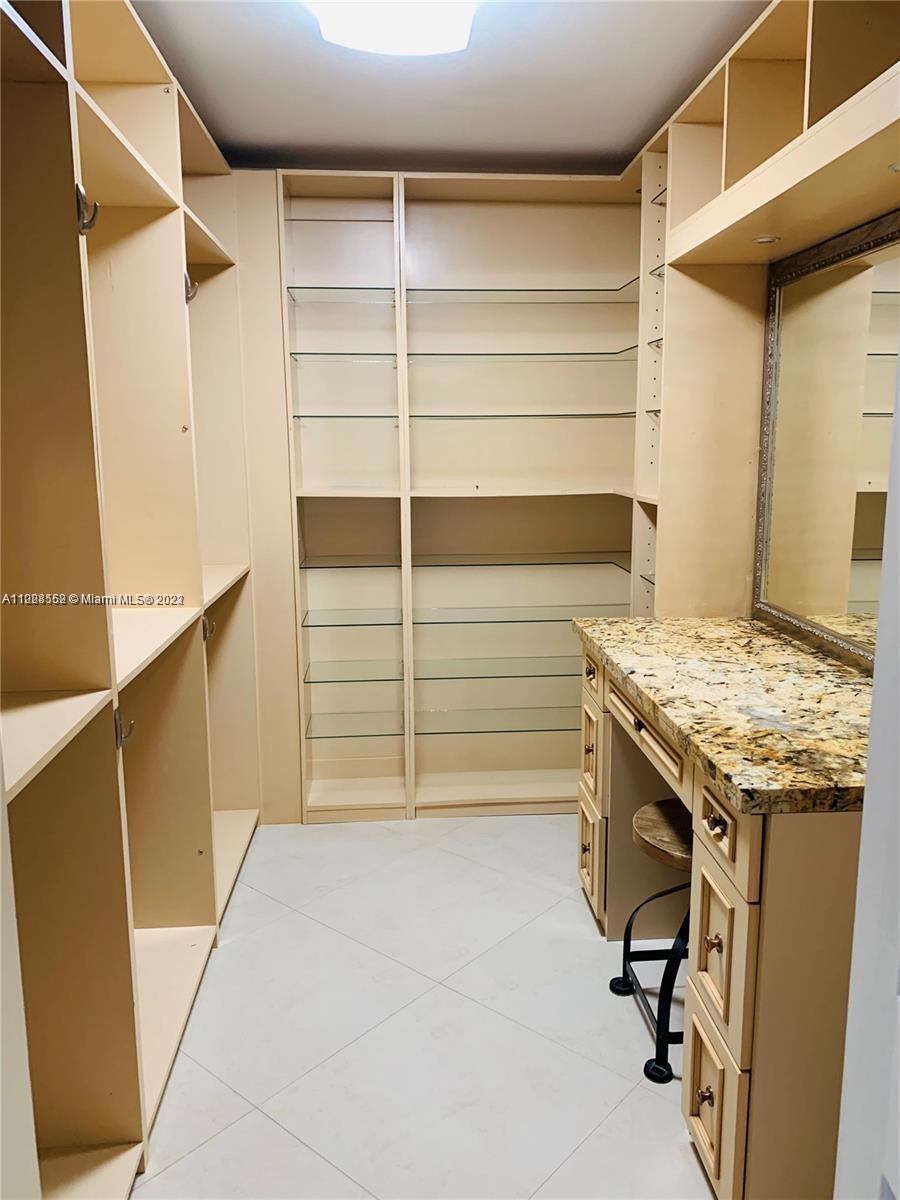 Glenvar Heights Miami, FL 33143 - Photo 14 of 19 a view of walk in closet with empty racks