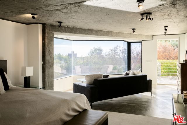 a living room with furniture and a floor to ceiling window