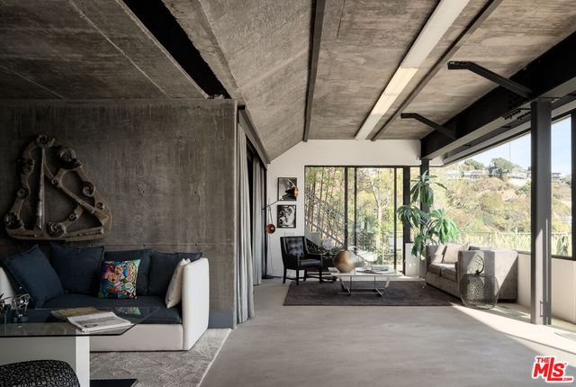 a living room with furniture flowers and a chandelier