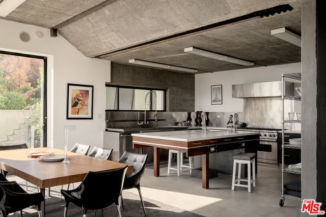 a living room with furniture a floor to ceiling window and outdoor view