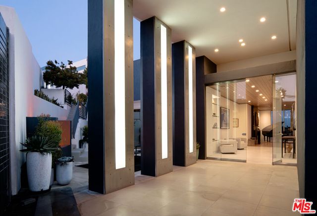 a view of a hallway with dining room and furniture