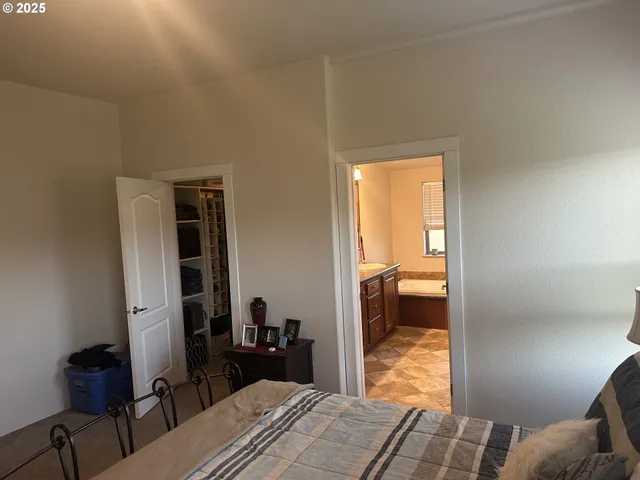 a bedroom with a bed and a view of bedroom