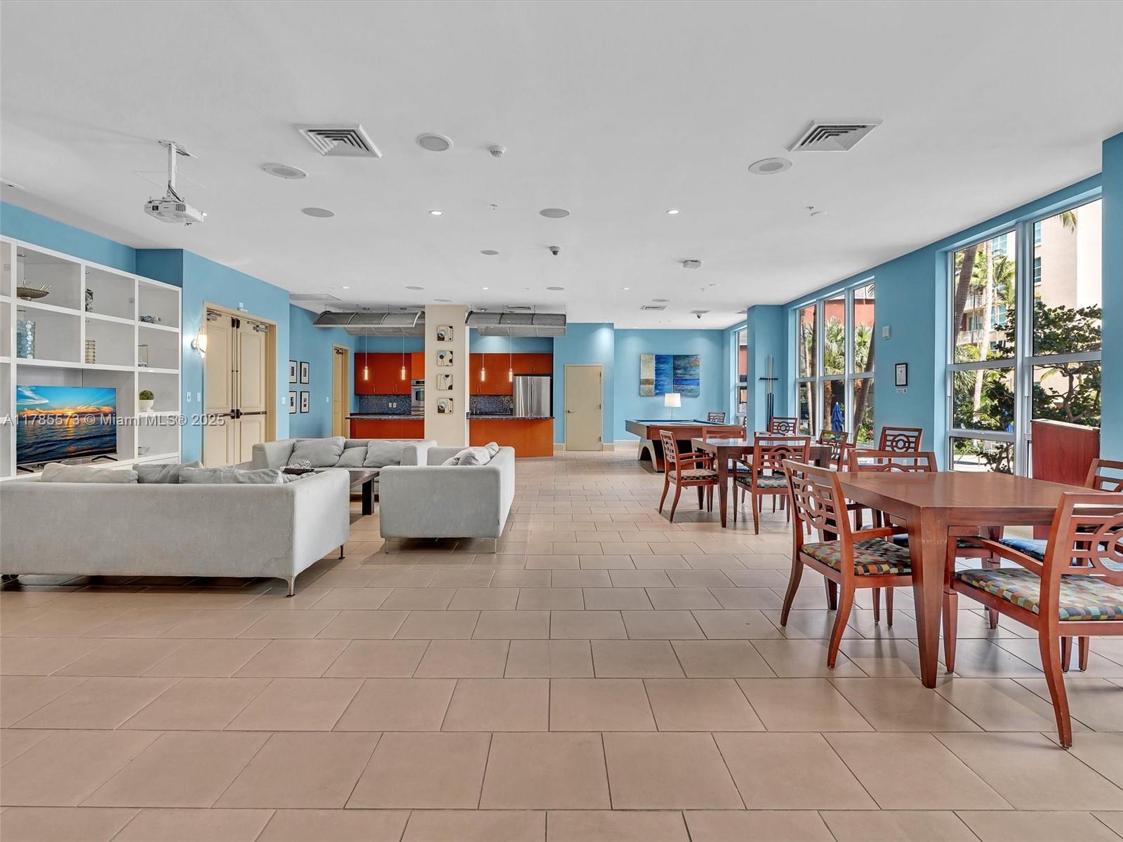 2001 Biscayne Boulevard, Unit 3413 Miami, FL 33137 - Photo 12 of 15 a living room with furniture and a dining table with projector the view