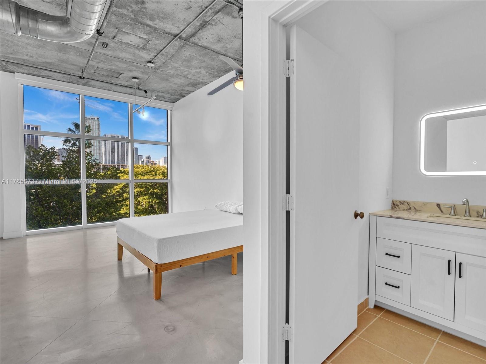 2001 Biscayne Boulevard, Unit 3413 Miami, FL 33137 - Photo 3 of 15 a view of a room with furniture and windows