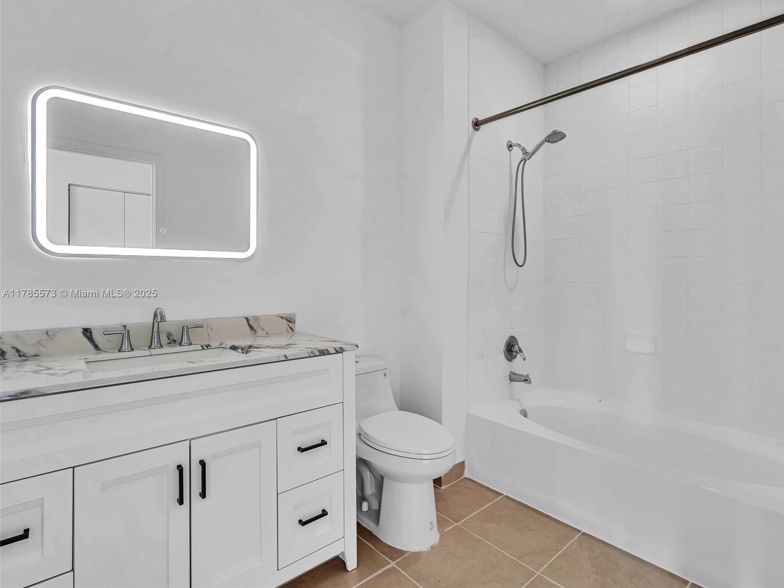 2001 Biscayne Boulevard, Unit 3413 Miami, FL 33137 - Photo 4 of 15 a bathroom with a granite countertop sink a toilet and a bathtub