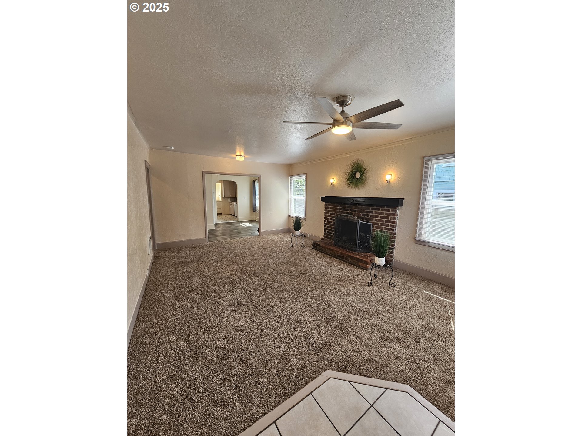 1760 West Broadway Eugene, OR 97402 - Photo 4 of 40 a living room with furniture and a fireplace