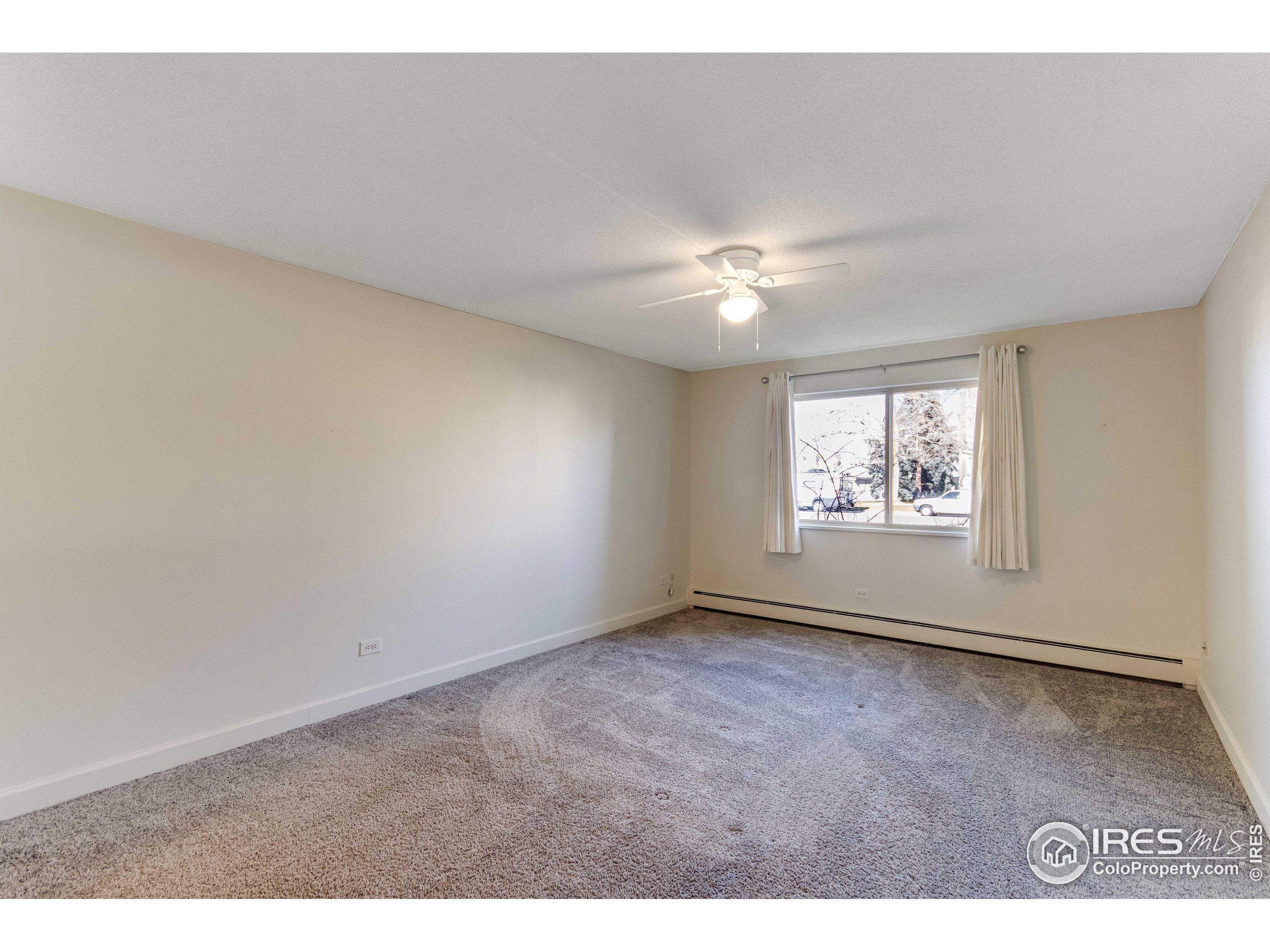 735 South Alton Way Denver, CO 80247 - Photo 11 of 29 an empty room with windows and fan