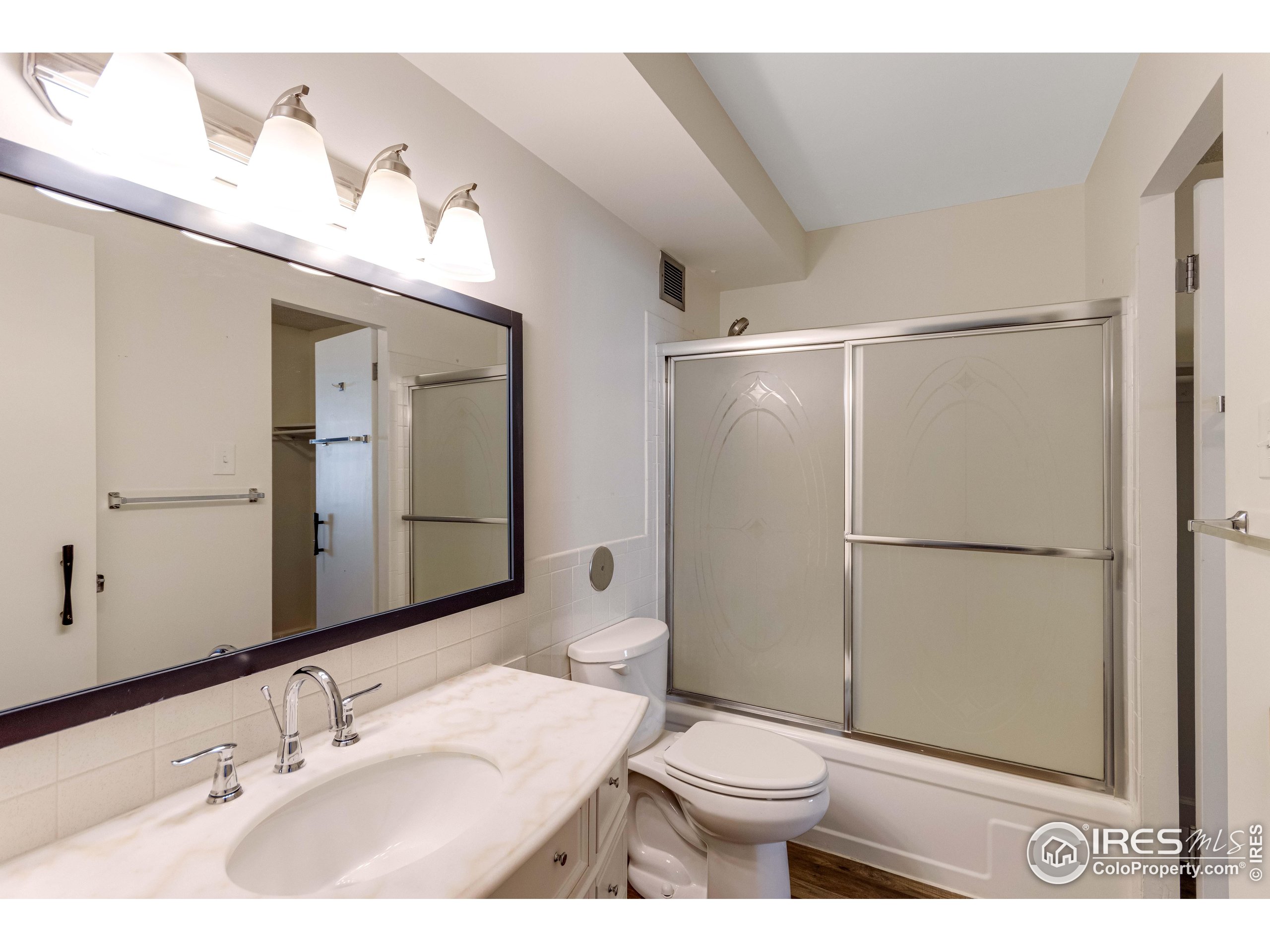 735 South Alton Way Denver, CO 80247 - Photo 15 of 29 a bathroom with a sink a toilet and shower