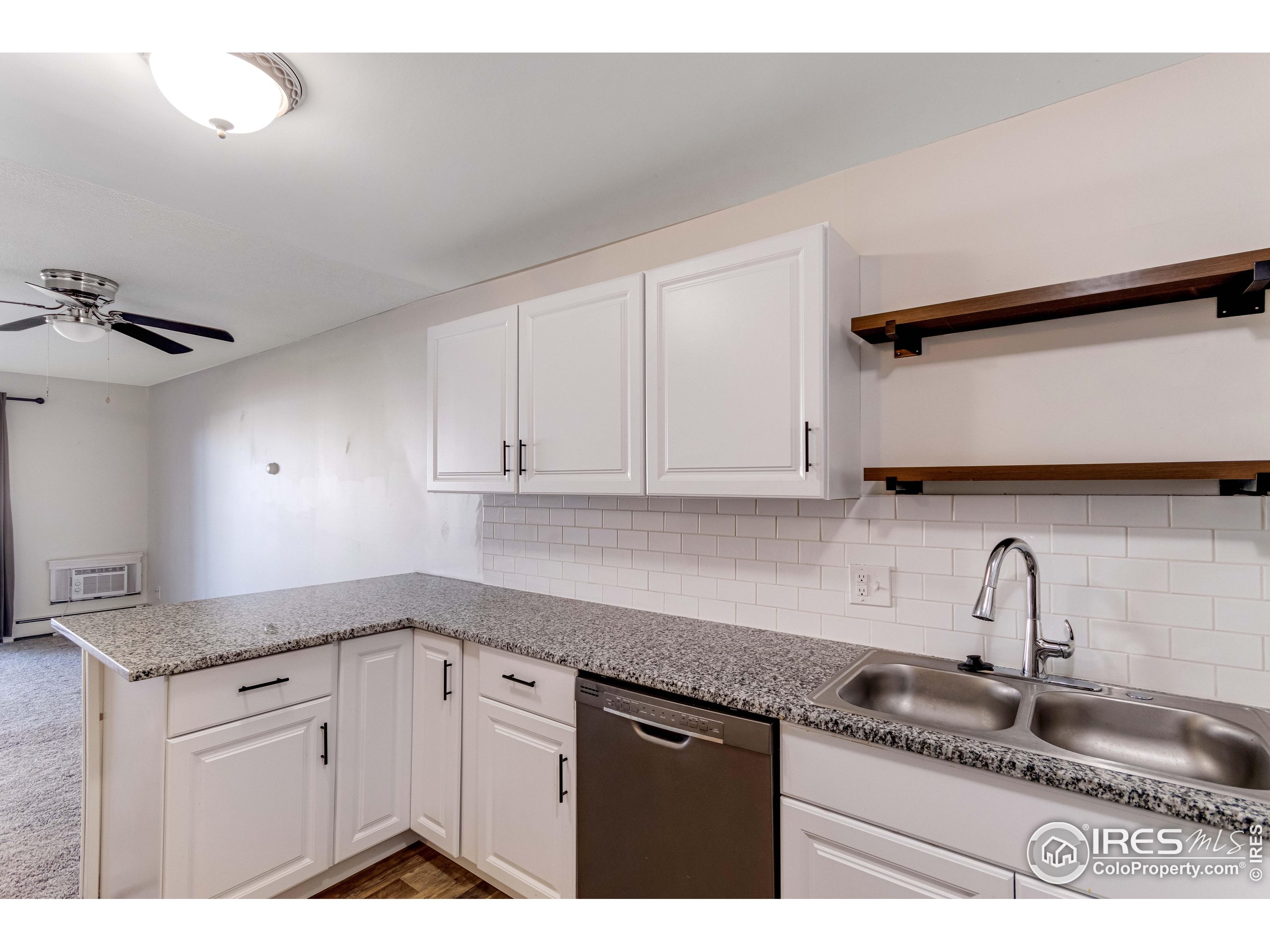 735 South Alton Way Denver, CO 80247 - Photo 6 of 29 a kitchen with granite countertop a sink a stove and cabinets