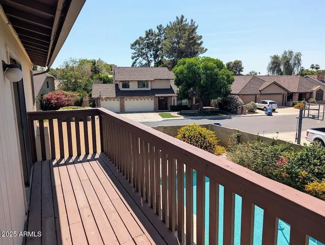 a view of balcony with wooden floor and outdoor seating