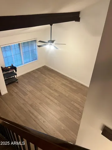 a view of a room with wooden floor