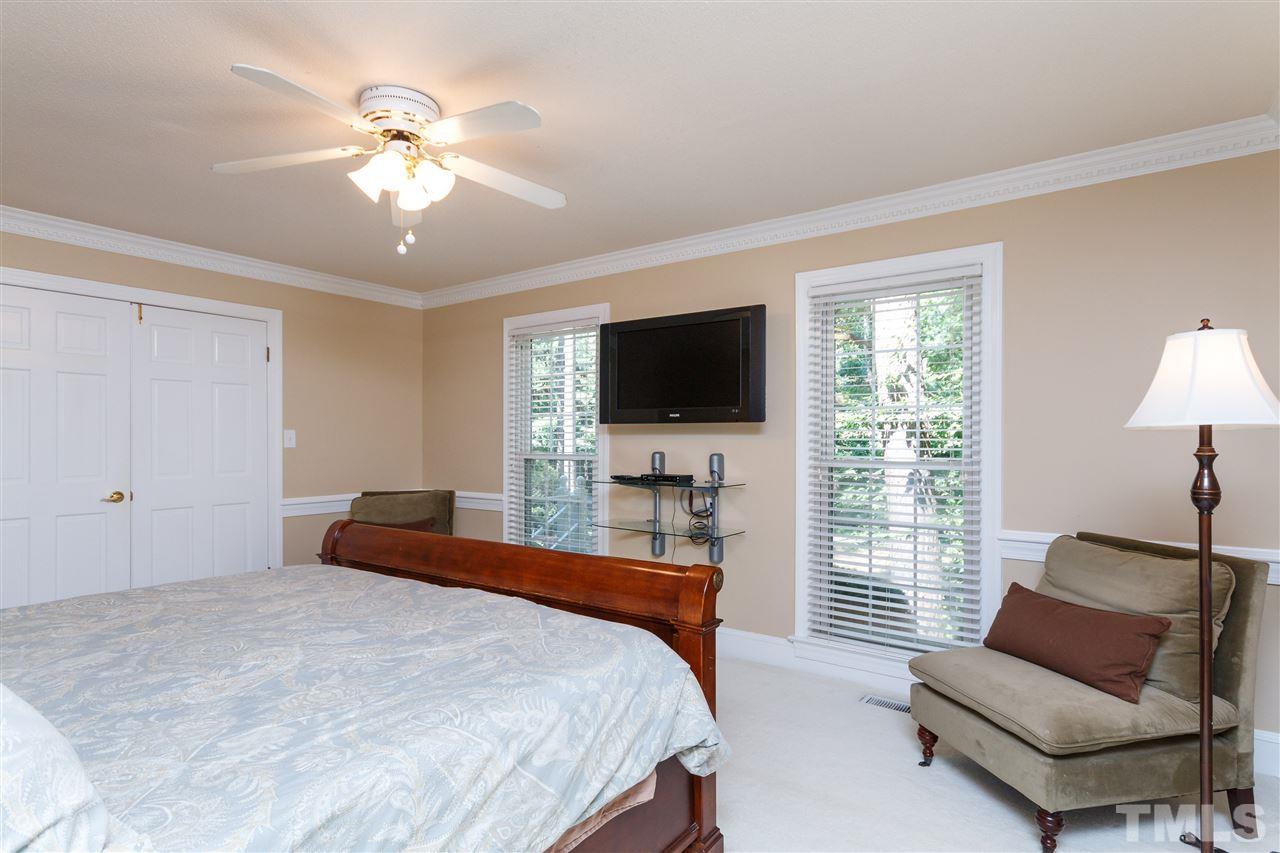 4921 Springwood Drive Raleigh, NC 27613 - Photo 13 of 25 a bedroom with a bed and a couch