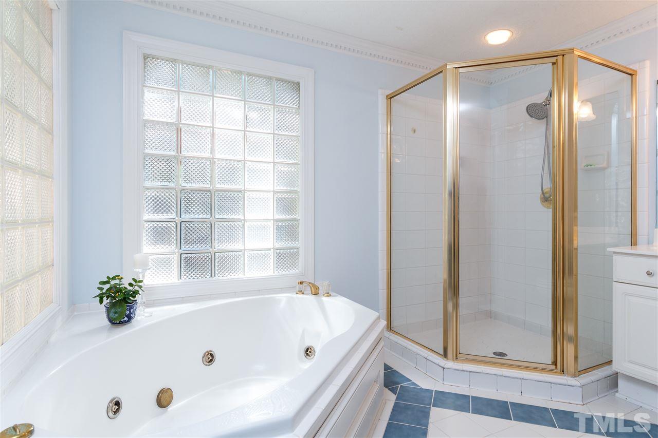 4921 Springwood Drive Raleigh, NC 27613 - Photo 14 of 25 a bathroom with a tub and shower