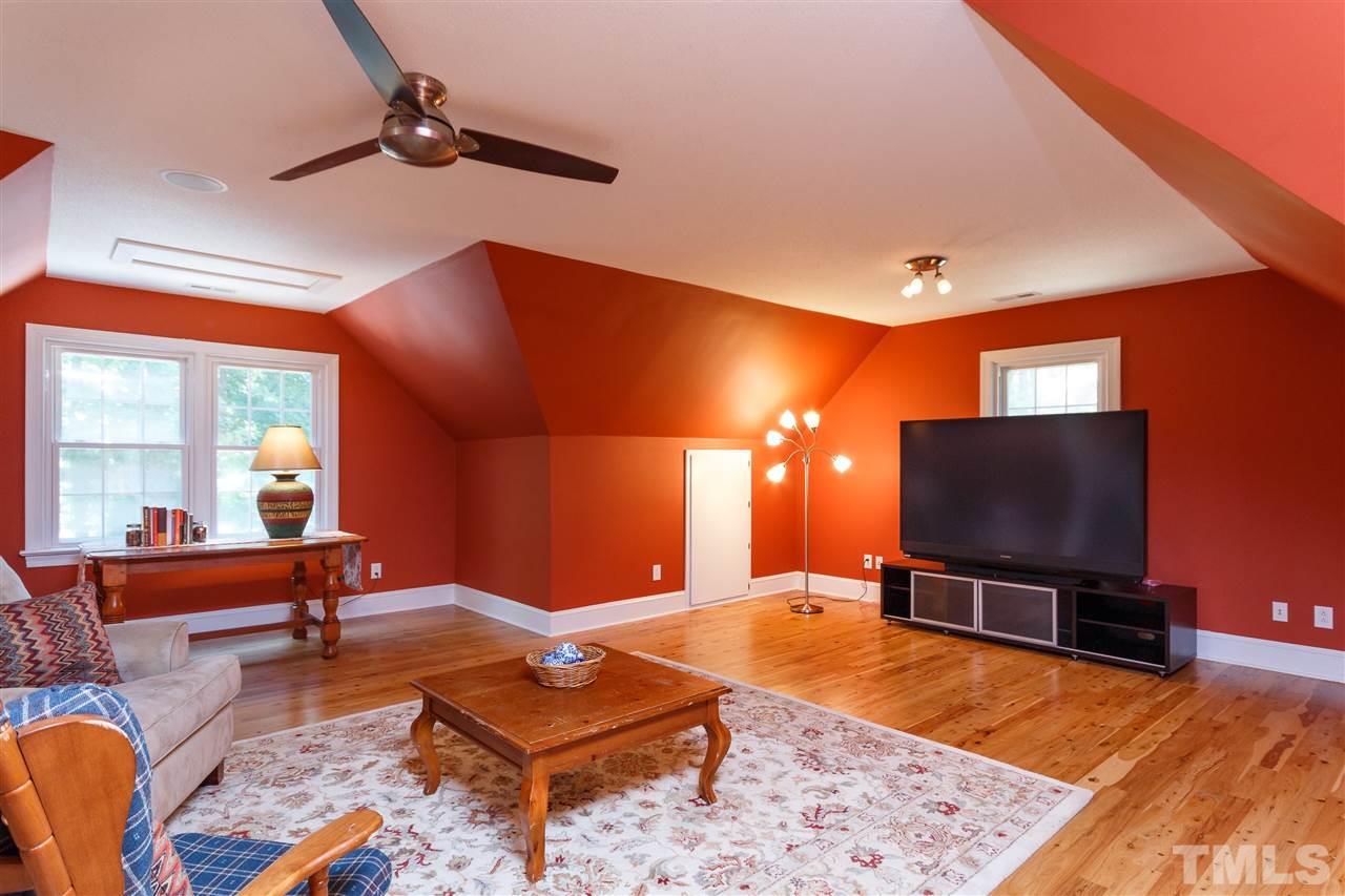 4921 Springwood Drive Raleigh, NC 27613 - Photo 15 of 25 a living room with furniture and a flat screen tv