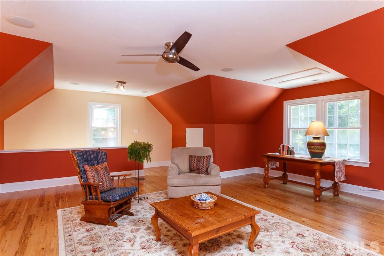 4921 Springwood Drive Raleigh, NC 27613 - Photo 16 of 25 a living room with furniture a table and a potted plant