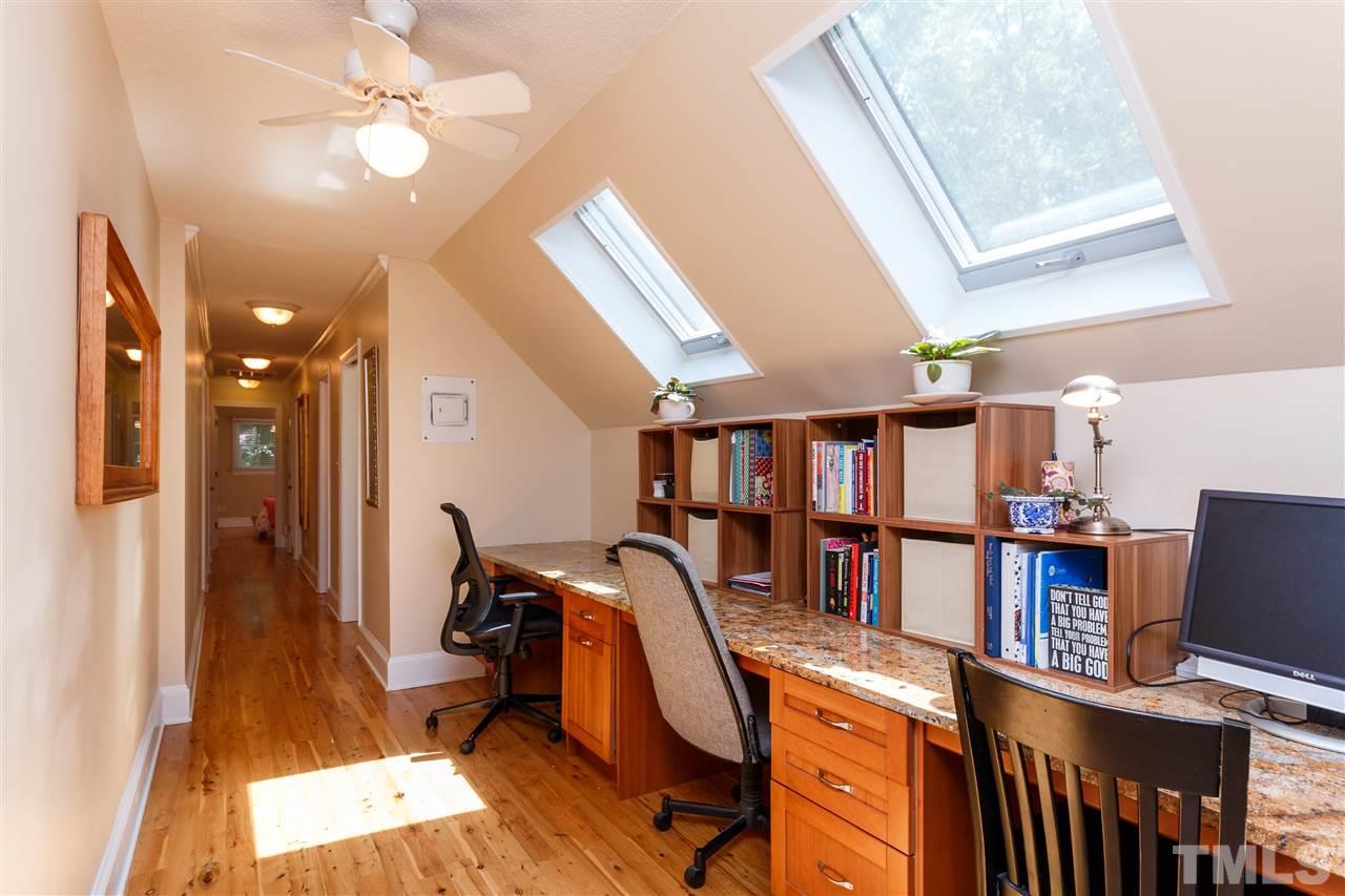 4921 Springwood Drive Raleigh, NC 27613 - Photo 17 of 25 a view of a workspace with furniture and a window
