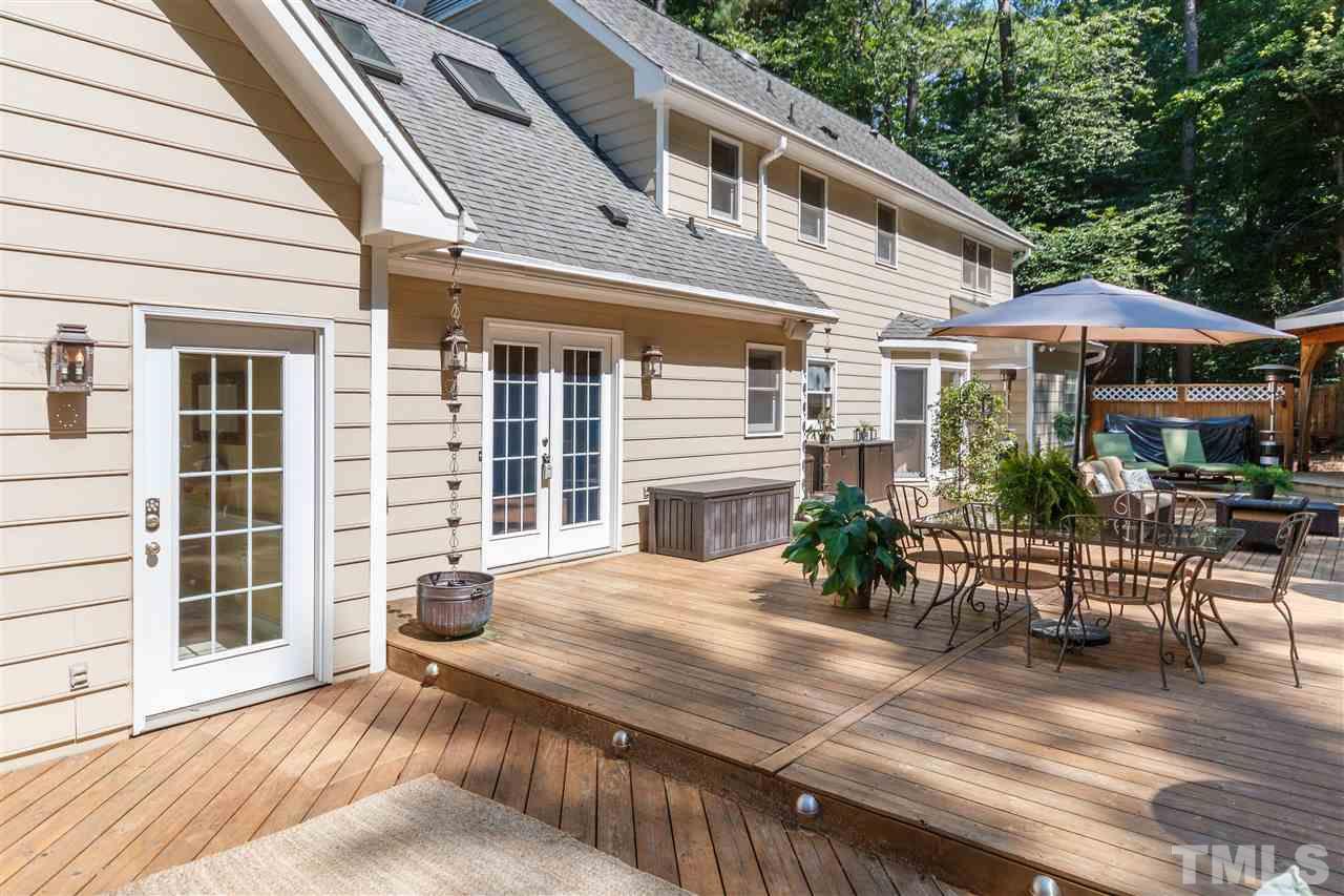 4921 Springwood Drive Raleigh, NC 27613 - Photo 22 of 25 a view of a house with backyard and sitting area