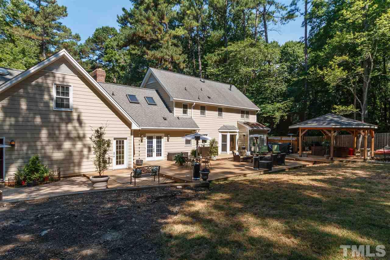 4921 Springwood Drive Raleigh, NC 27613 - Photo 23 of 25 a front view of a house with garden