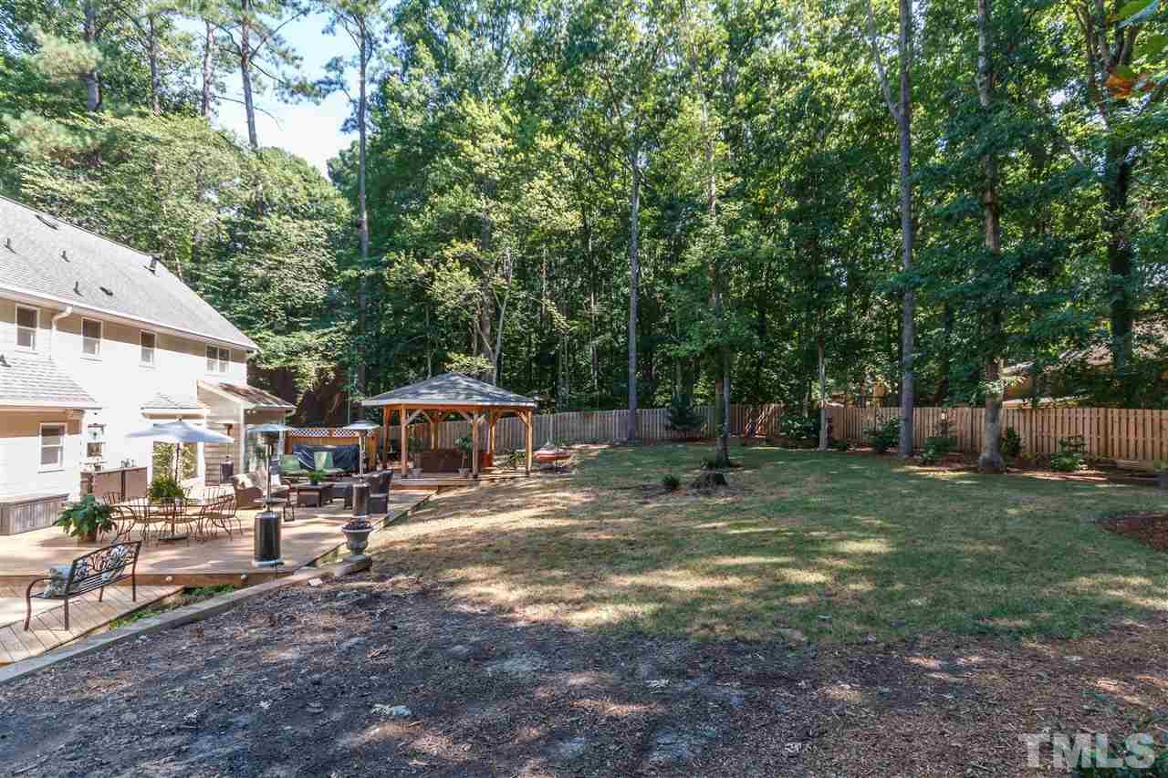 4921 Springwood Drive Raleigh, NC 27613 - Photo 24 of 25 a backyard of a house with yard barbeque oven and outdoor seating