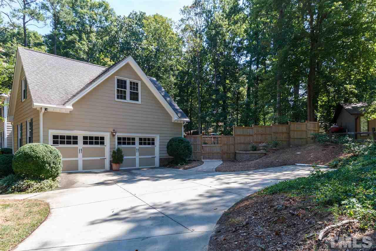 4921 Springwood Drive Raleigh, NC 27613 - Photo 25 of 25 a view of a house with a yard plants and large tree