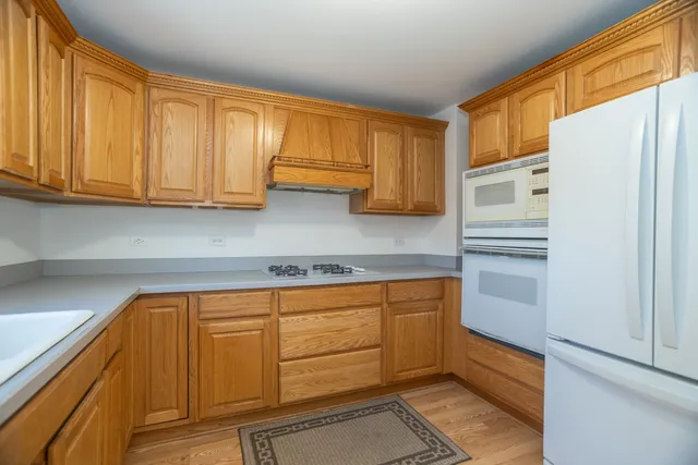 a kitchen with stainless steel appliances granite countertop a refrigerator and cabinets